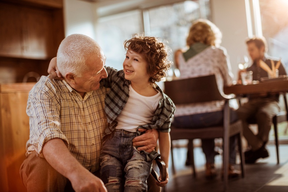 Grandfather hugging his grandchild.
