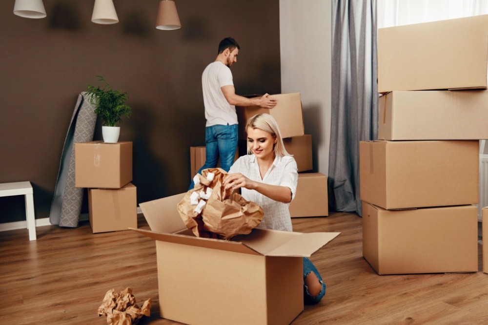 A couple unpacking boxes after moving home.