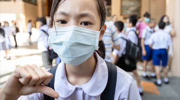 Asian girl student wearing medical face mask in school, epidemic, spread of germ, Coronavirus