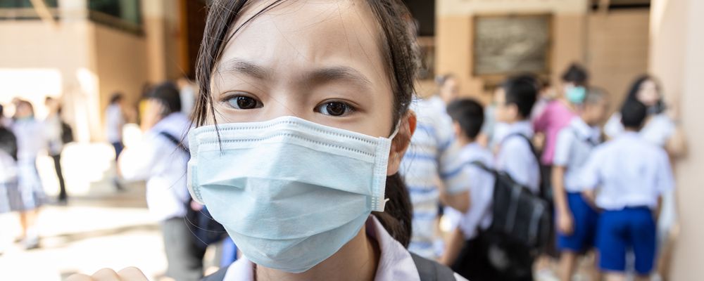 Asian girl student wearing medical face mask in school, epidemic, spread of germ, Coronavirus