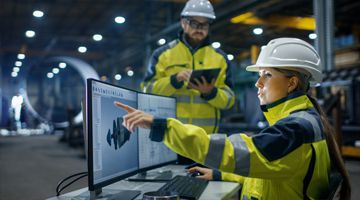 Female Industrial Engineer Works on Personal Computer